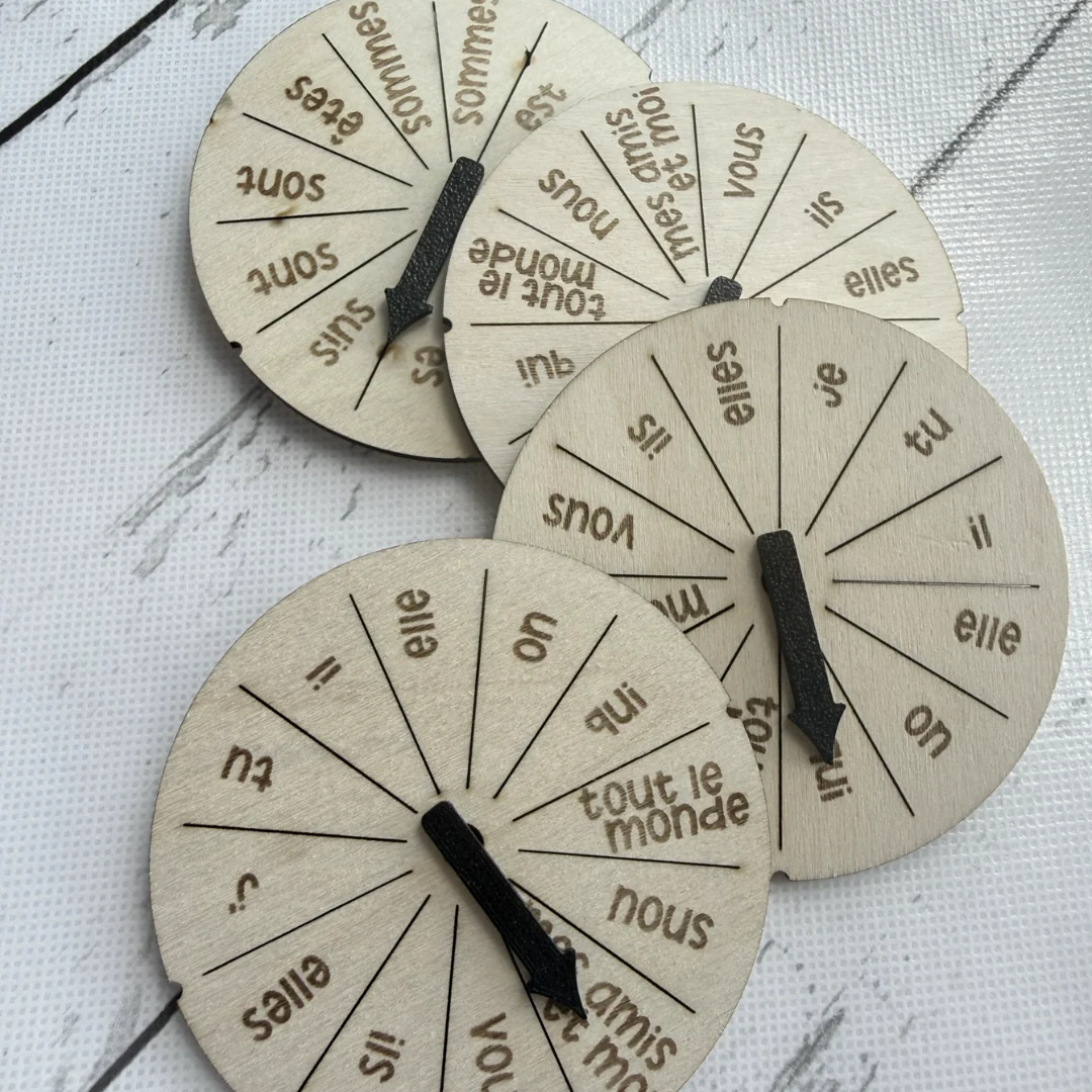 Four wooden French verb conjugation wheels for avoir, être, aller and faire